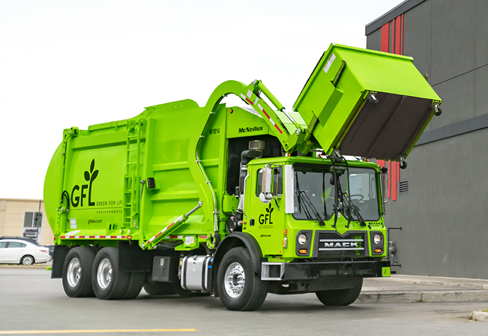 Green GFL truck lifting a dumpster