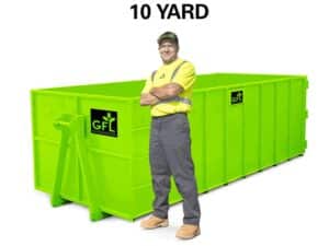A man stands in front of a green 10 yard GFL roll off dumpster