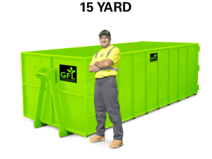 A man stands in front of a green 15 yard GFL roll off dumpster
